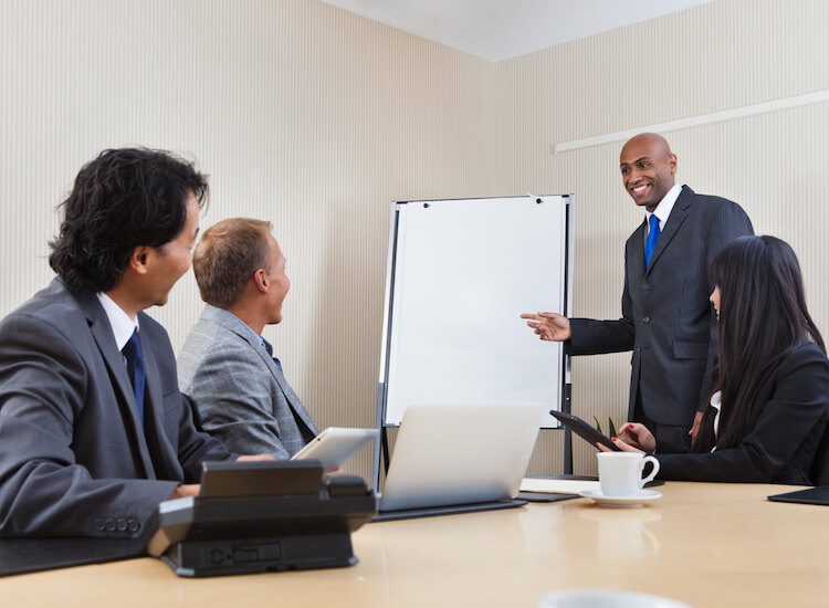 Assessment Consulting meeting at a table with four people.