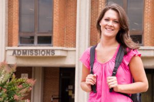 college student with backpack leaving admissions office at university.