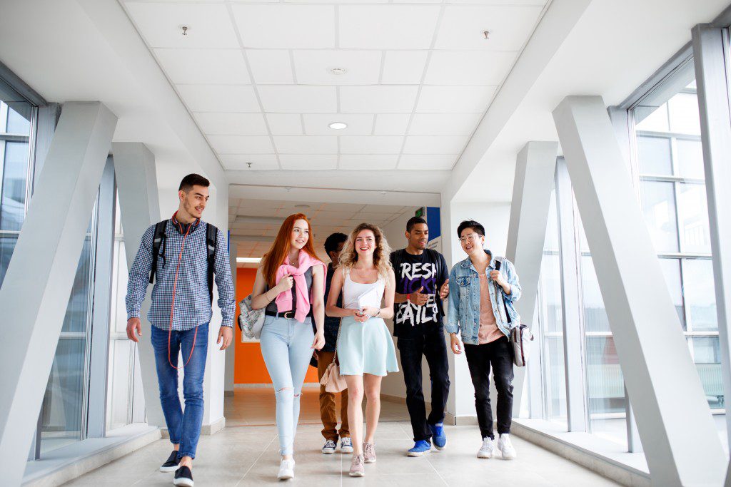 Group of students walking through hallway