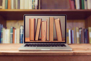 instructional technology laptop screen showing books from a library essential for distance education infrastructure